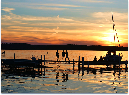 Fishing peer with boats docked; dusk at Madison lake