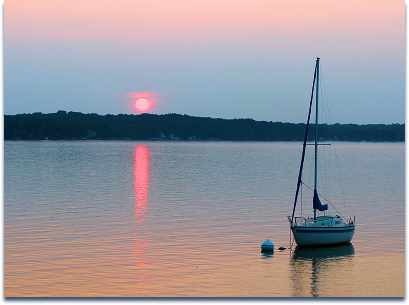 Sailboat on Madison lake at sunset